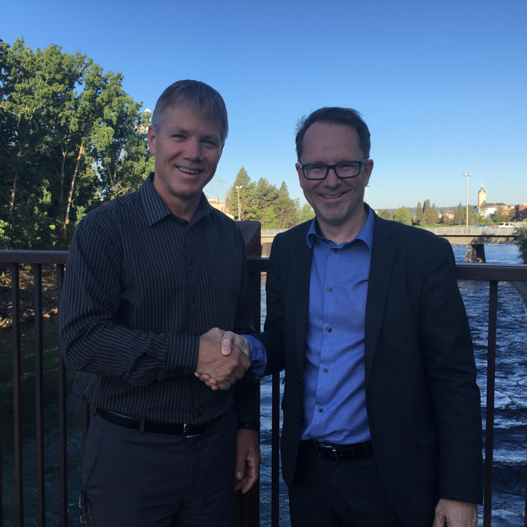 Two businessmen seal a deal with a firm handshake, expressing mutual trust and agreement.